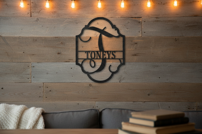 Family Name Plaque Steel Sign in black mounted on a rustic reclaimed wood shiplap wall with warm Edison bulb lighting